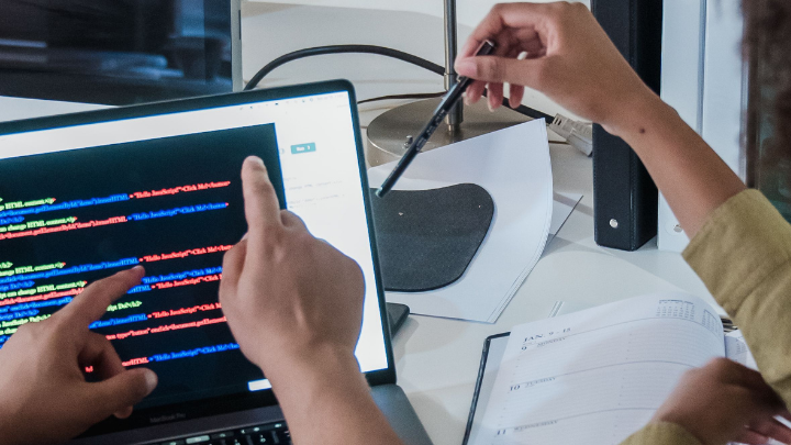 Enterprise technology team reviewing code during a delayed IT initiative